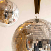Close-up of two Hazel & George Dazzling Disco Balls, showing the mirrored mosaic tiles in detail