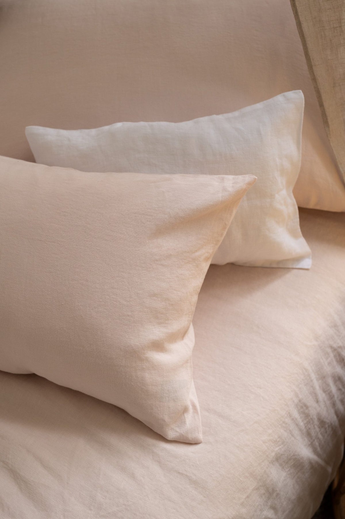 Hazel &amp; George Linen Duvet Cover in Craie, with two matching pillows on a bed