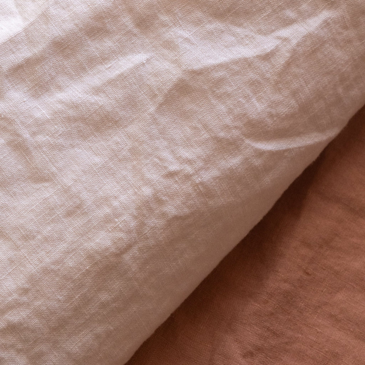 Close-up of the linen fabric of the Hazel &amp; George Duvet Cover in Craie, showing the natural texture