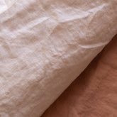 Close-up of the linen fabric of the Hazel & George Duvet Cover in Craie, showing the natural texture