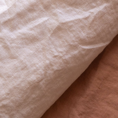 Close-up of the linen fabric of the Hazel &amp; George Duvet Cover in Craie, showing the natural texture