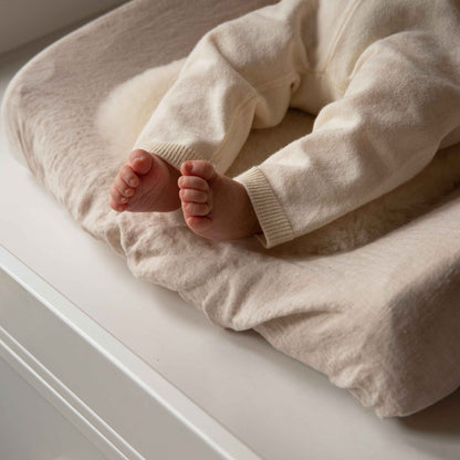 Hazel &amp; George Linen Changing Mat Cover in Naturel, close-up of a baby&