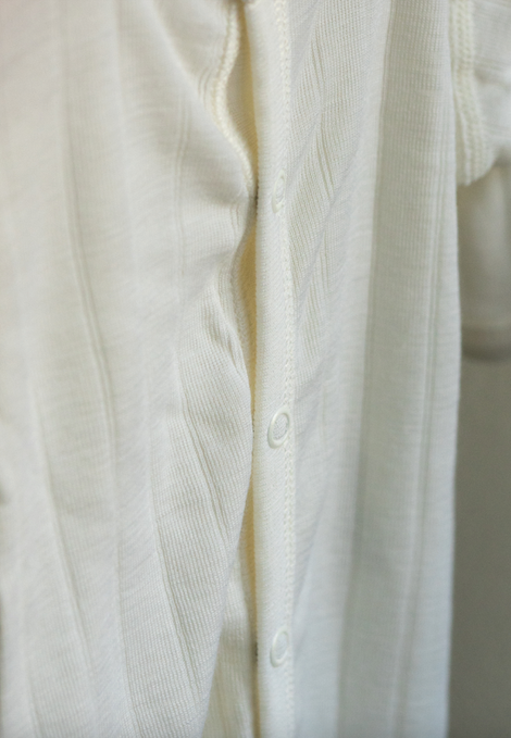 Close-up of a white shirt with buttons on a light background