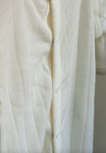 Close-up of a white shirt with buttons on a light background