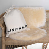 Binibamba sheepskin snuggler in Milk, shown on a plain background