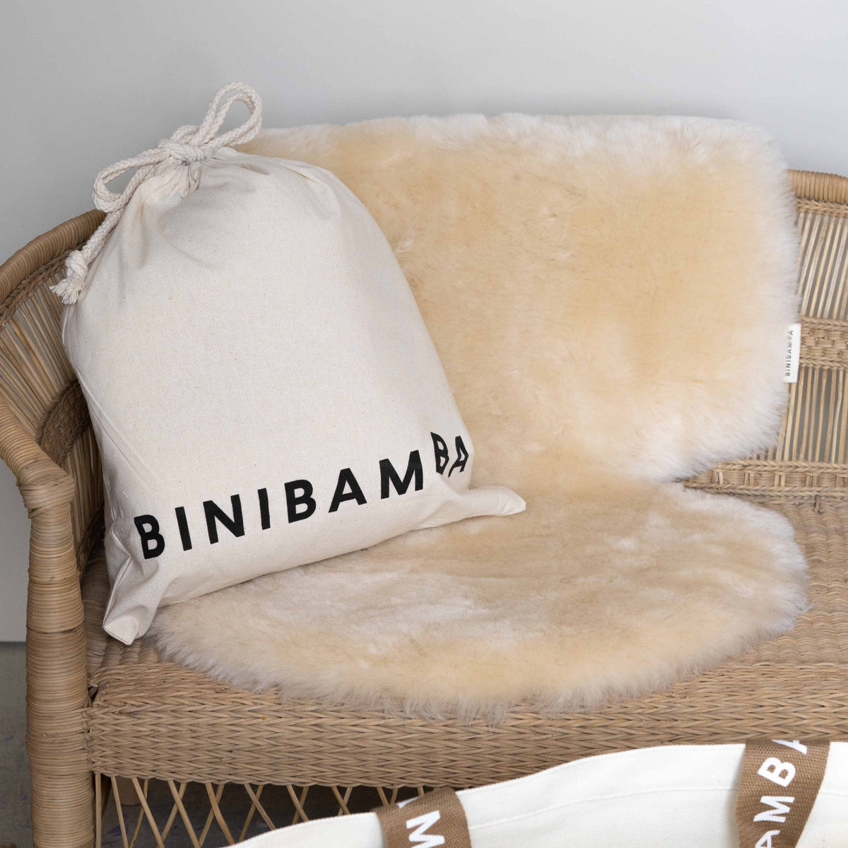 Binibamba sheepskin snuggler in Milk, shown on a plain background