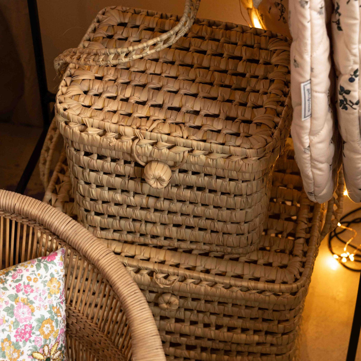 Set of three natural palm leaf storage baskets with lids from Tine K Home, shown together in different sizes
